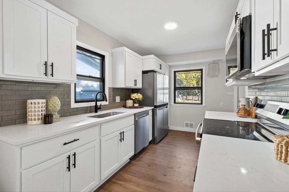 White cabinets with a gray subway tile backsplash in a Wyoming, MN kitchen remodel