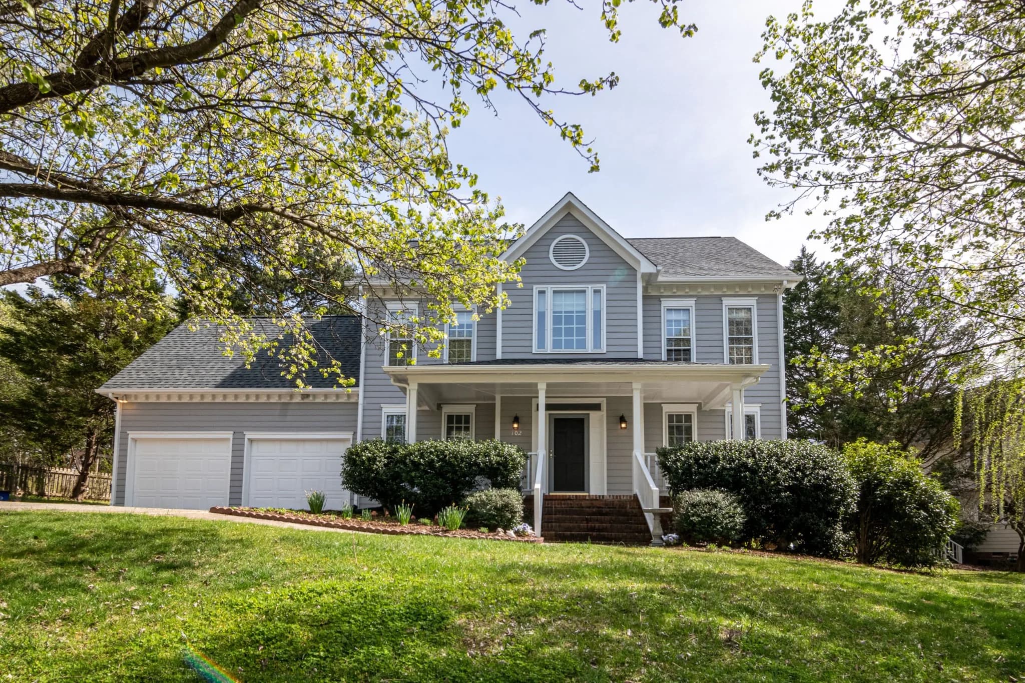 Exterior house painting on a two-story home by Curb Appeal Remodeling